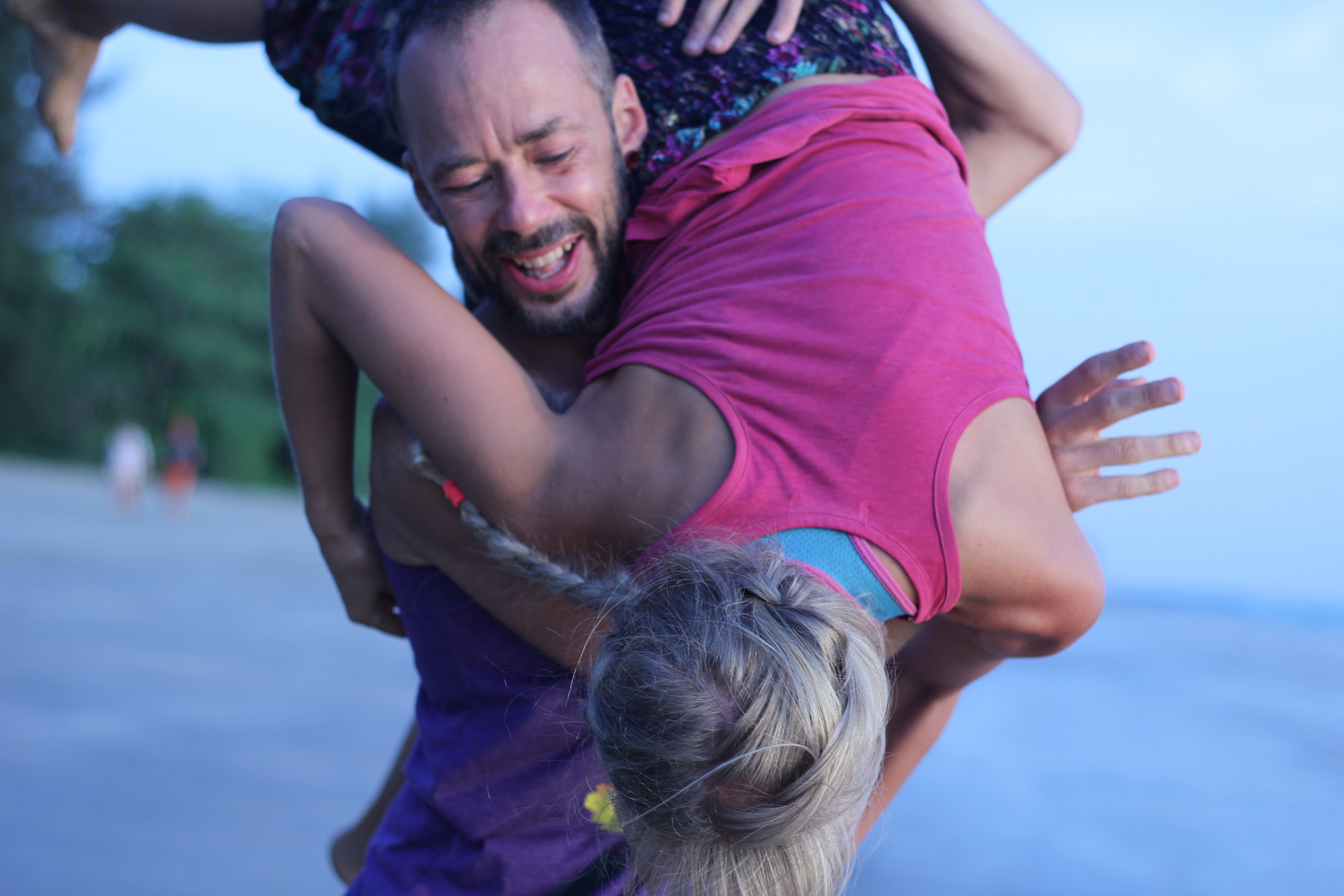 Gabriel and Elinmaria dancing contact improvisation in front of the blue sea