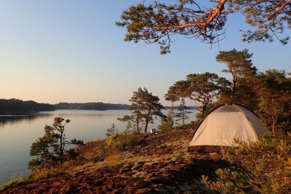A tent on a hill in front of the archipelago sea