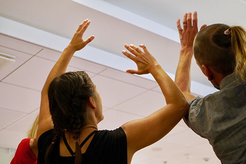 Two dancers with their hands in the air