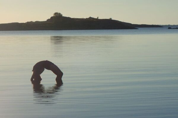 ElinMaria in a yoga pose on the seawater